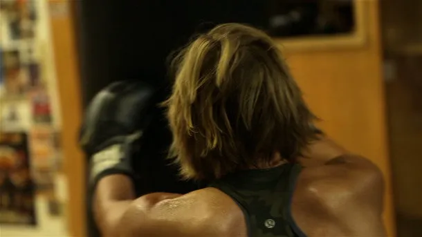 Woman Hits Punching Bag
